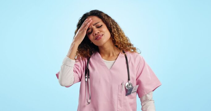 Headache, doctor and woman in studio with medical burnout, stress and tired of healthcare challenge on blue background. Frustrated, depressed and sick nurse with fatigue, brain fog or risk of mistake