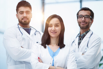 Three medical colleagues stand in the lobby of the hospital