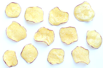 Various sweet potato chips on white background.