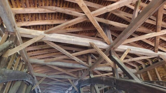 Roberts covered bridge in Eaton Ohio. Walking gimbal stabilized shot that shows the inside roof construction. Trusses, sheathing and diagonal bracing are visible.