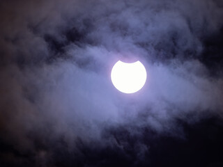Partial Eclipse of the Sun in October 2023 With Clouds