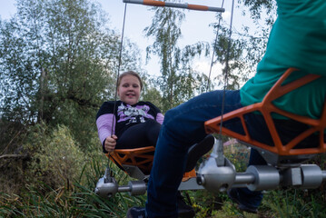 A girl is playing on the playground.