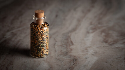 A small glass bottle filled with a blend of five spices called 