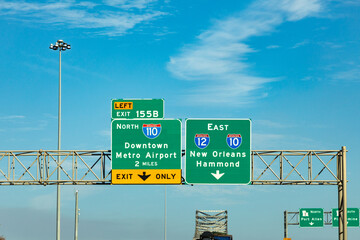 sign at highway interstate downtown metro airport to 110 north and direction New Orleans to highway...