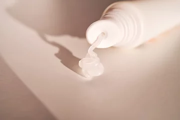 Fotobehang Hygienic moisturizing lip balm in a tube on a white background. © Marevgenna