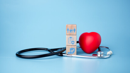 The concept of health insurance and medical welfare. Block wooden and red heart with plus icon....