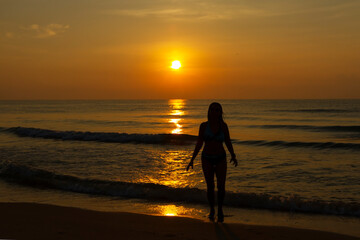 Fototapeta na wymiar Woman body big with bikini and sunrise on beach
