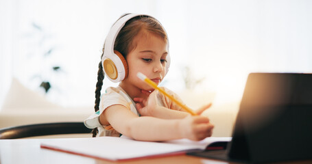 Girl, headphones and writing in book for elearning, education or study on desk at home. Female...