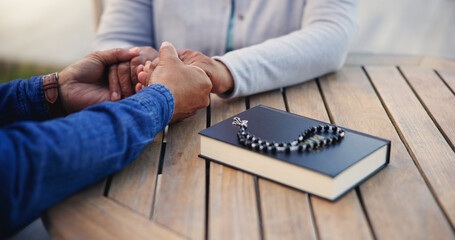 Bible, praying or couple holding hands on table together in a Christian belief with hope or faith....