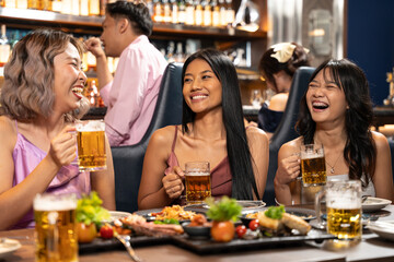 Beautiful Asian woman is Relishing a Delightful Dinner with Friends at a Bar, Immersed in the Joy of a Vibrant Night Party. They Enjoying with Night Party Together. Party and Celebration Concept.