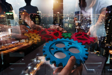 Business team work together and combine pieces of gears. Partnership and integration concept