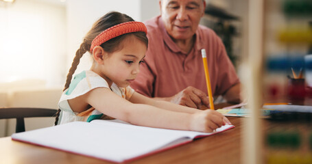 Grandfather, little girl and writing in book for learning, literature or education together on desk at home. Grandpa, child or kid taking notes in homeschool to read and write on table at house