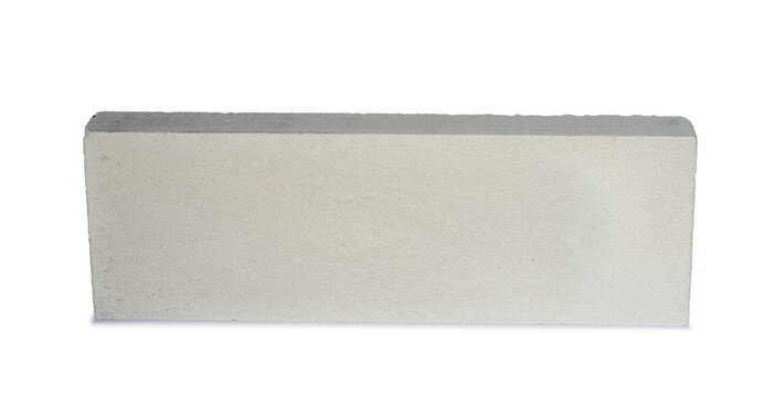 Aerated Concrete block isolated on white background. White lightweight brick, house wall assembly made from white aerated autoclaved concrete block. Solid gypsum modular pattern for light building.