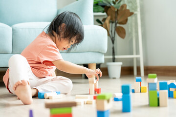 Happy Asian child playing and learning toy blocks. children are very happy and excited at home. child have a great time playing, activities, development, attention deficit hyperactivity disorder. - obrazy, fototapety, plakaty