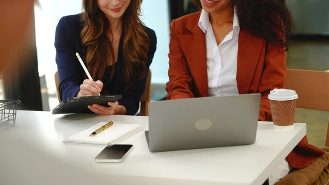 Two professional caucasian with african american businesswoman friends collaboration, working together at office, using laptop, Generally accepted audit standards, Earnings before interest and taxes