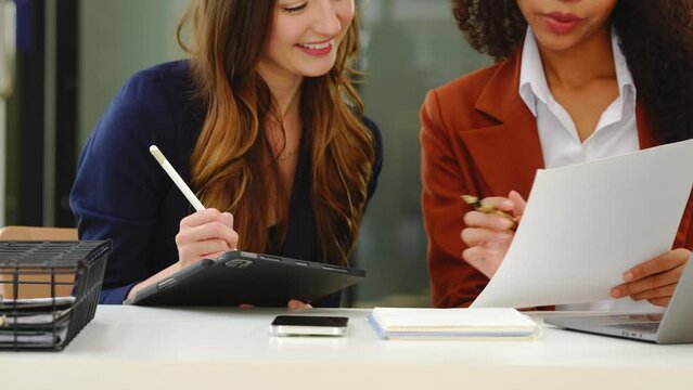 Two professional caucasian with african american businesswoman friends collaboration, working together at office, using laptop, Generally accepted audit standards, Earnings before interest and taxes