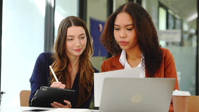 Two professional caucasian with african american businesswoman friends collaboration, working together at office, using laptop, Generally accepted audit standards, Earnings before interest and taxes