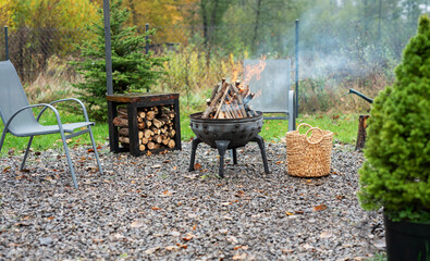 Fire pit and burning fire in a garden