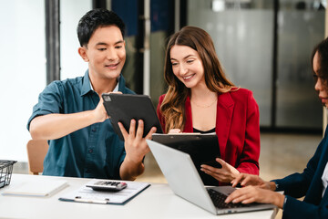 Fototapeta premium Diverse group of professionals engaging in discussion with laptop and clipboard, in bright office environment. qualified auditor report and opinion, asian people, african american, caucasian female