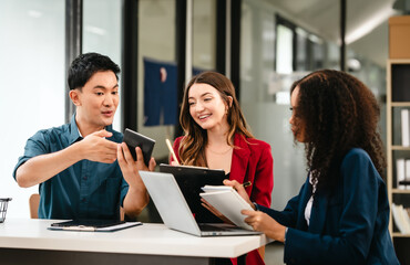 Fototapeta premium Diverse group of professionals engaging in discussion with laptop and clipboard, in bright office environment. qualified auditor report and opinion, asian people, african american, caucasian female
