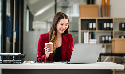 Caucasian businesswoman, likely an accountant or CPA, smiling and holding a coffee cup while...