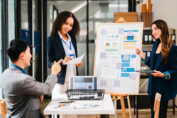 diverse team of professionals engaged in a website graphic design board meeting, sharing opinions on UX and UI design elements. Asian man, African American people, black, afro, caucasian female