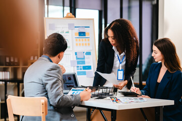 diverse team of professionals engaged in a website graphic design board meeting, sharing opinions on UX and UI design elements. Asian man, African American people, black, afro, caucasian female