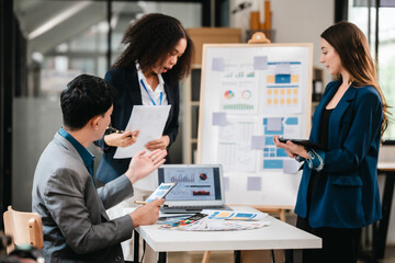 diverse team of professionals engaged in a website graphic design board meeting, sharing opinions on UX and UI design elements. Asian man, African American people, black, afro, caucasian female