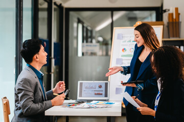diverse team of professionals engaged in a website graphic design board meeting, sharing opinions on UX and UI design elements. Asian man, African American people, black, afro, caucasian female