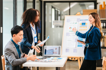 diverse team of professionals engaged in a website graphic design board meeting, sharing opinions on UX and UI design elements. Asian man, African American people, black, afro, caucasian female
