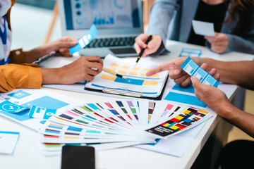 diverse team of professionals engaged in a website graphic design board meeting, sharing opinions on UX and UI design elements. Asian man, African American people, black, afro, caucasian female