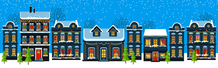 Cute Christmas and winter houses. Snowy night in cozy Christmas town city panorama. Winter village night landscape Christmas outdoor decorations.