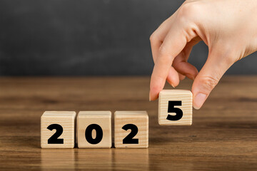 2025 on Wooden Block. Merry Christmas and Happy New Year, 2025 new year idea concept. Going in...