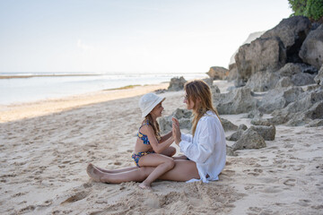 Mother and daughter spend time at the beach. Love, happiness, family concept