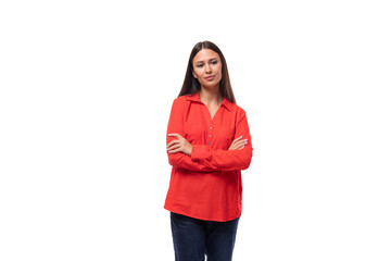portrait of a young european brunette office worker woman dressed in a red loose shirt on a white background