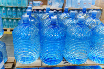 Bottles with clean water in a hyper package. Sale of drinking water. Selective focus