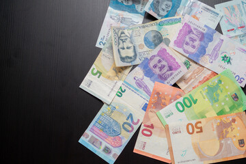 top shot of various euro banknotes and Colombian banknotes showing the concept of currency exchange, currency comparison and international economy