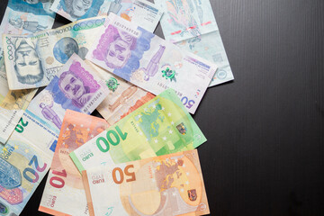 top shot of various euro banknotes and Colombian banknotes showing the concept of currency exchange, currency comparison and international economy