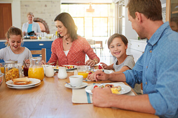 Food, breakfast and love with a family in the dining room of their home together for nutrition. Portrait of a boy with his parents and sister eating at a table in an apartment for morning bonding