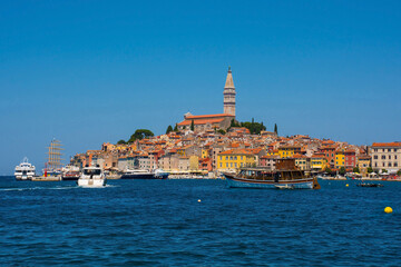 Boats on the historic waterfront of the medieval coastal town of Rovinj in Istria, Croatia. Saint Euphemia Church is central