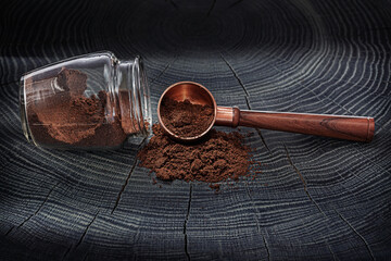 Coffe Spoon And Jar With Coffee Ground On Wooden Background.