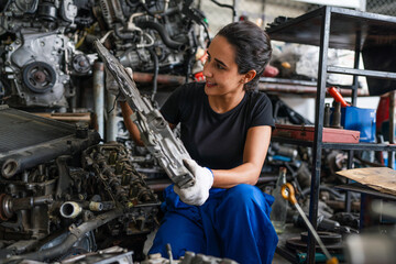 Fototapeta na wymiar Female auto mechanic are repair and maintenance auto engine is problems. Engineer inspecting motor part problems. Woman empowerment working in automotive maintenance service industry.
