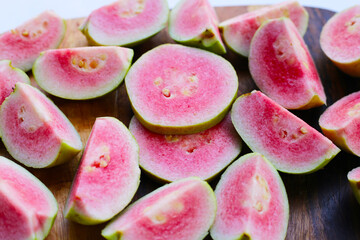 Fresh pink guava on cutting board