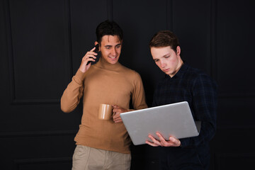 Two young attractive friends are communicating. Students posing in the studio.