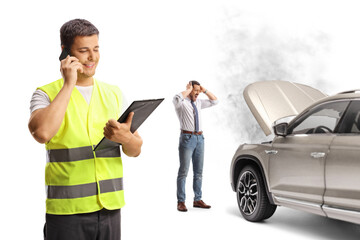 Road help worker using a mobile phone and a shocked man standing in front of a car breakdown