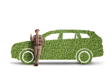 Elderly man leaning on a green electric vehicle and gesturing thumbs up