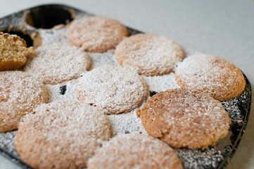 Fresh baked muffins in a muffin tin. Closeup