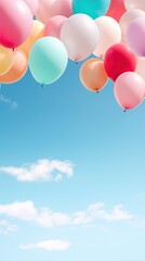 Pastel colors balloons bunch in blue sunny sky background with copy space