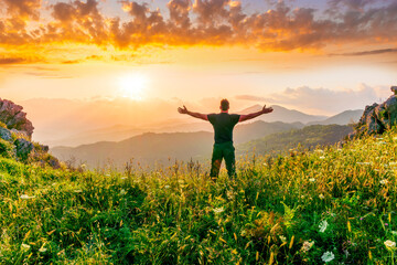 Fototapeta premium man doing hiking sport in mountains with anazing highland view