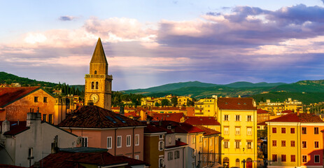 amazing evening town with church, tower with bell , yellow houses and beautiful hills with nice cloudy sky on background, european cityscape of Italy - obrazy, fototapety, plakaty